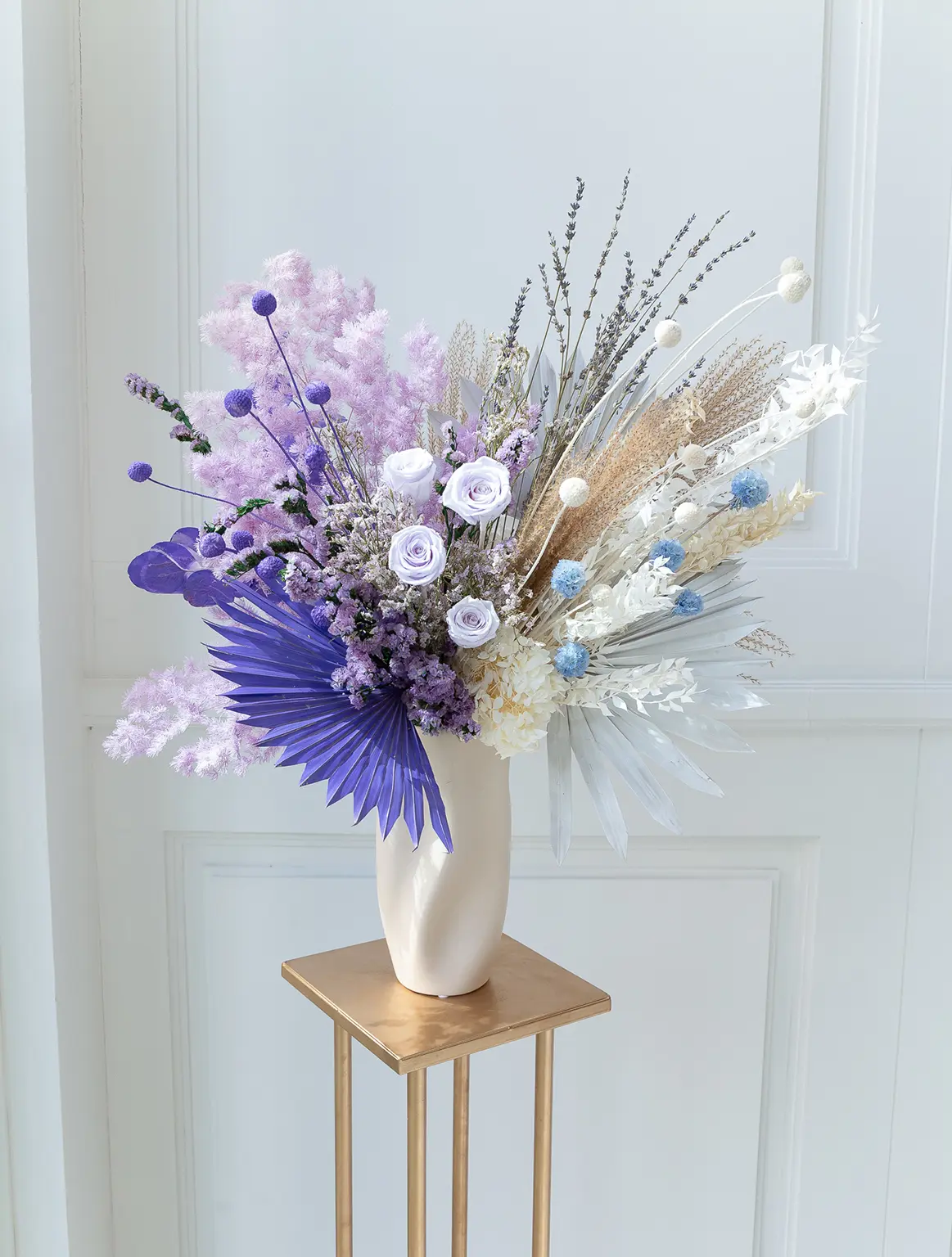 dried flower arrangement blue white vase