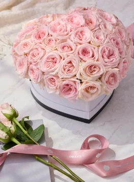 50 roses in a white heart-shaped box