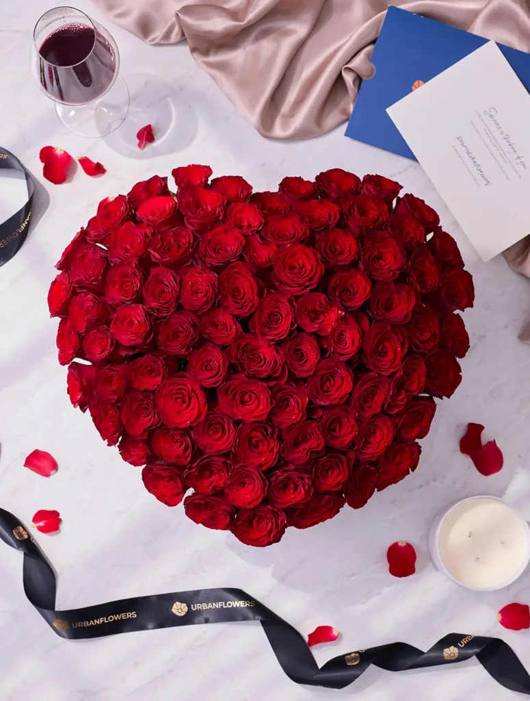 100 premium red roses with a black heart-shaped flower box