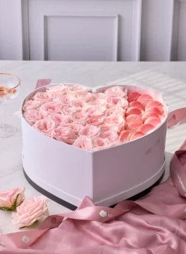 Heart-shaped flower box, pink roses and macarons