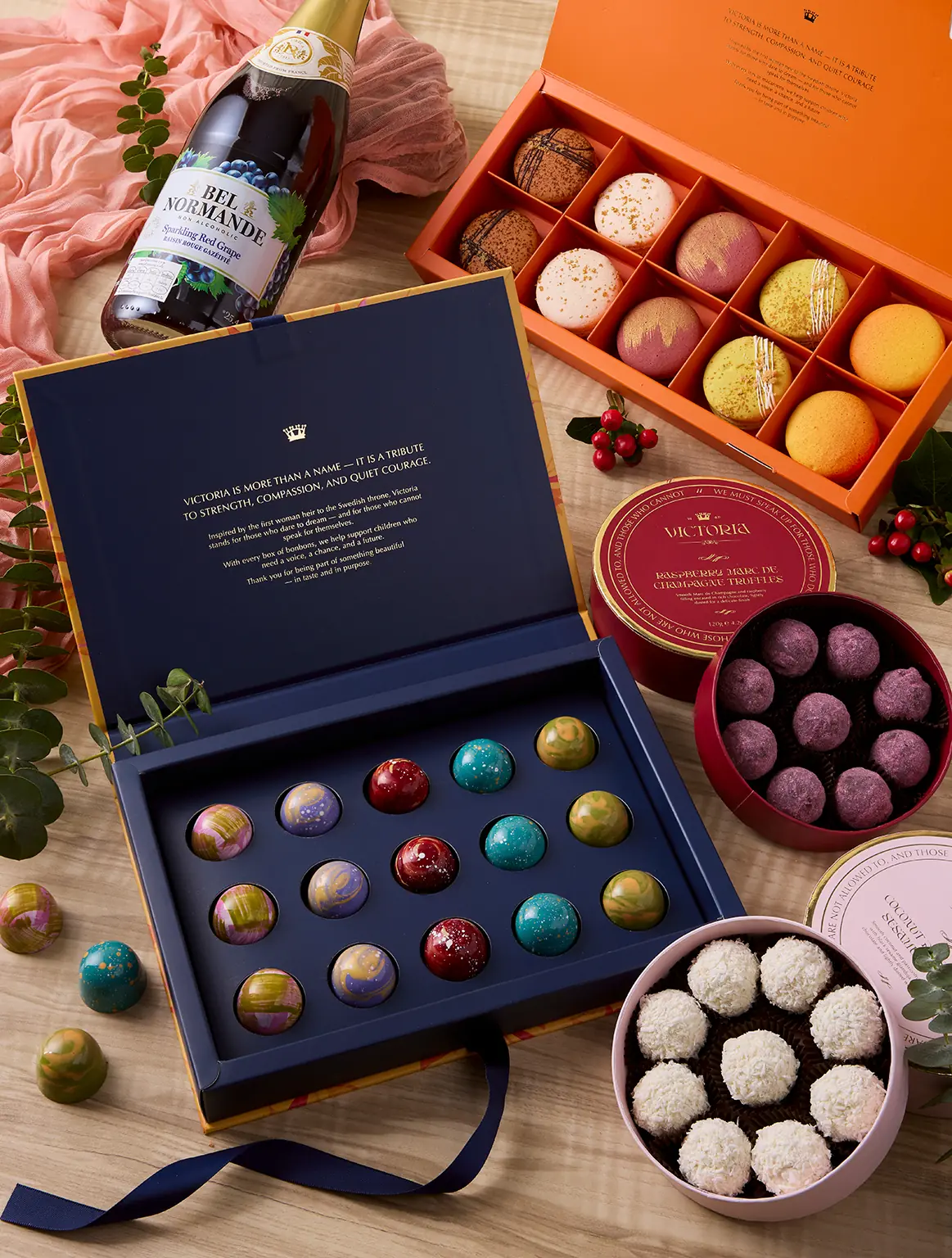 Chocolate & Bubbles Hamper with Belgian pralines, truffles, macarons, and sparkling red grape juice by UrbanFlowers.