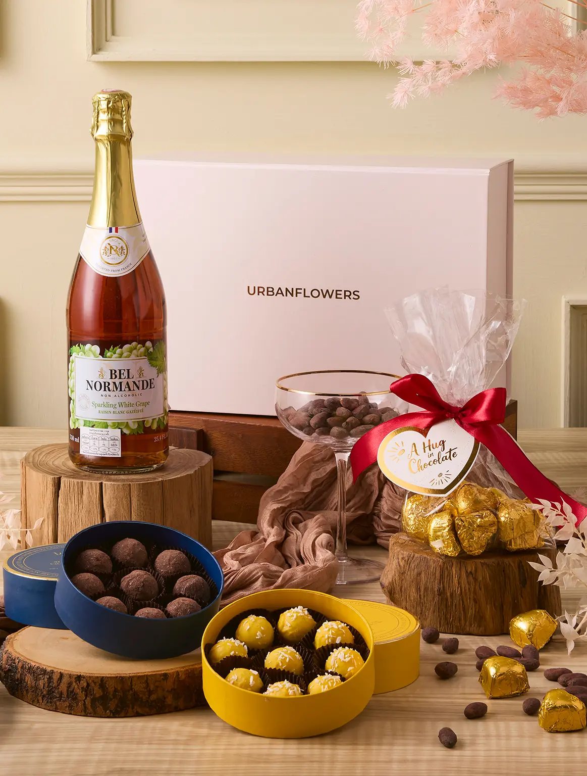 Hug in Chocolate Hamper with Belgian truffles, chocolate hearts, and sparkling white grape juice by UrbanFlowers.