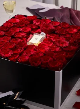 Red roses and Jo Malone perfume in a premium black square flower box.