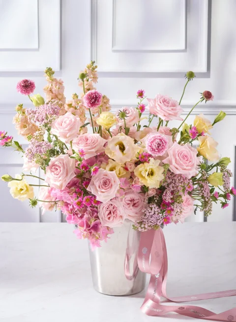 Flowers in a champagne bucket, roses and pink pearls