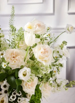 Flowers in a champagne bucket, cotton flowers and white roses