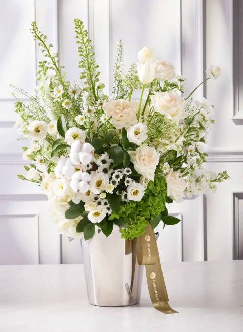 Flowers in a champagne bucket, white and green flowers