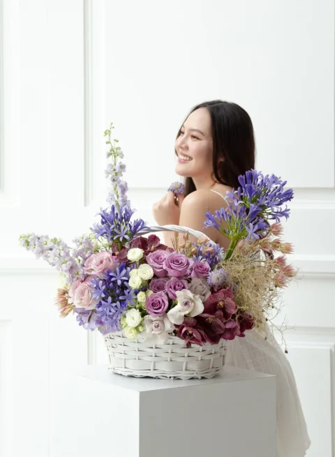 A flower basket of fresh, luxurious purple flowers from orchids.