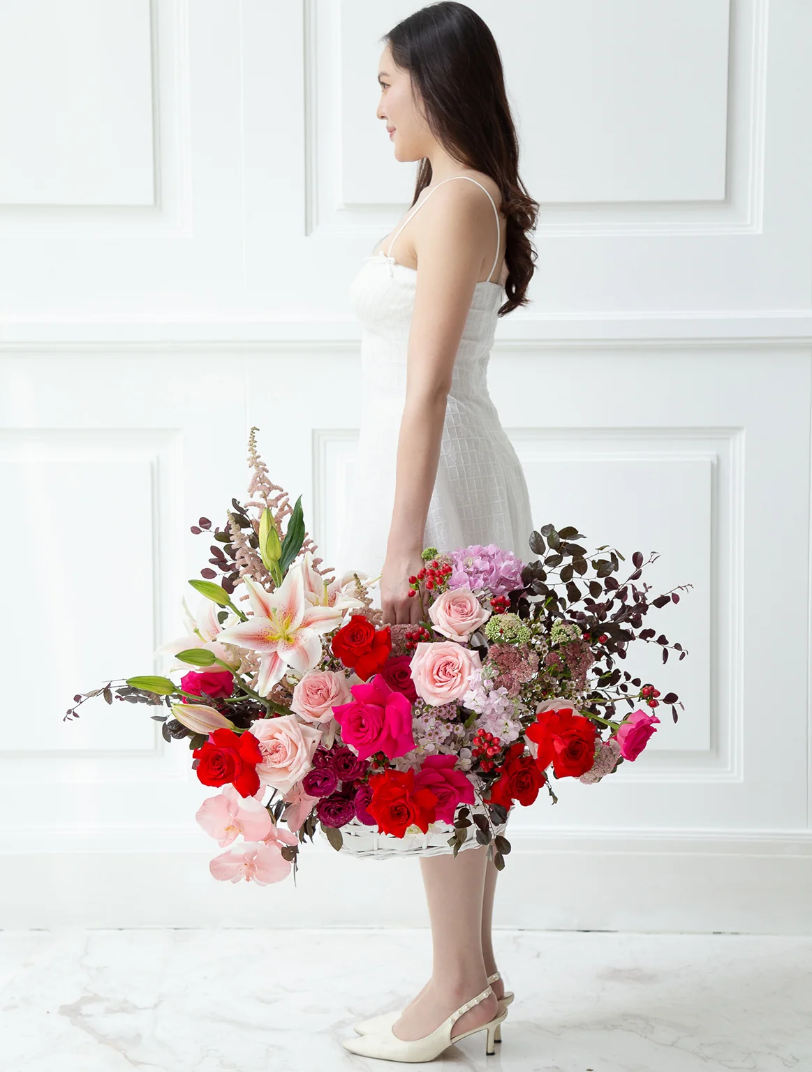 A luxurious pink and red flower basket