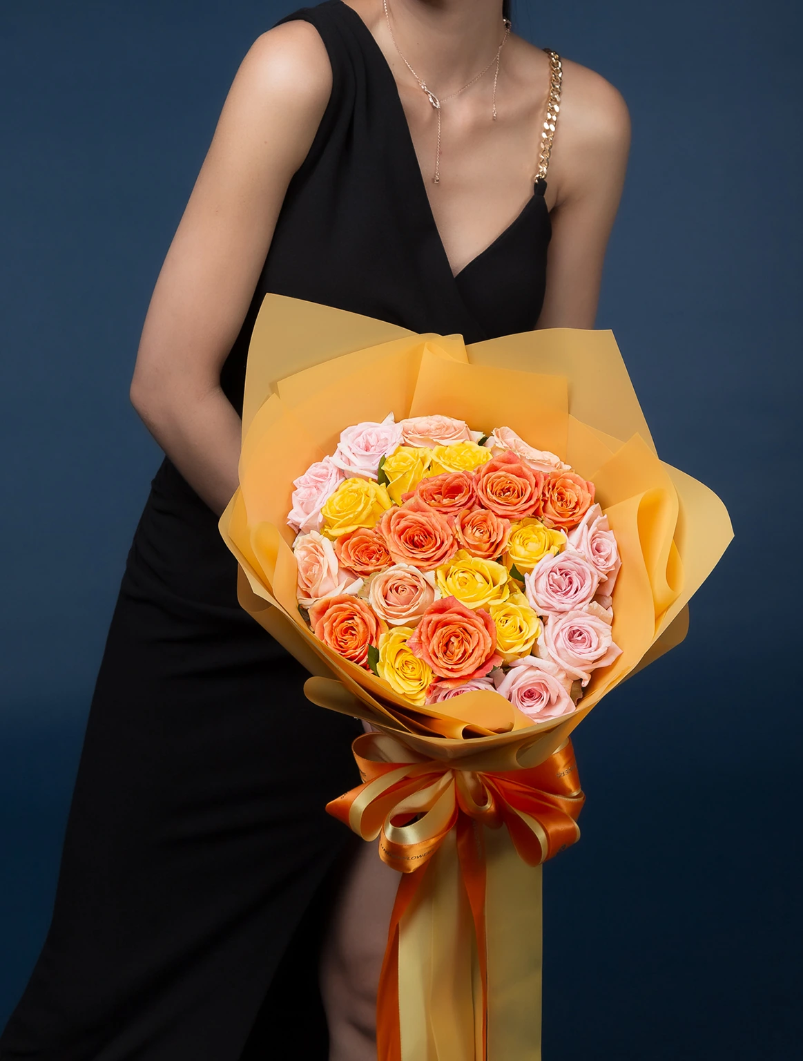 Bouquet of yellow, orange, pink roses