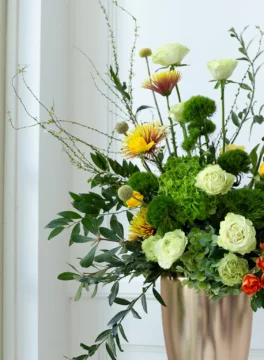 Flower vase, green hydrangeas and green roses