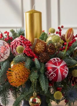 Christmas flower vase, holly branches and gold candles