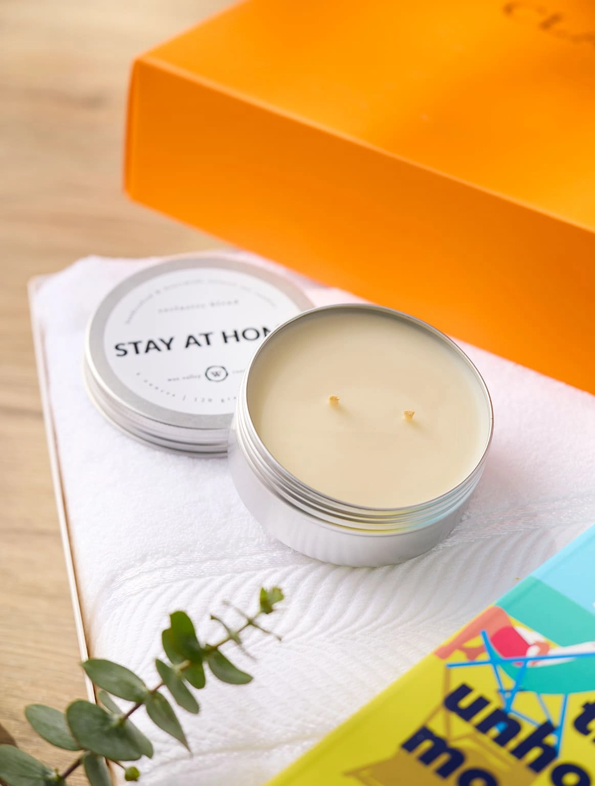 stay-at-home-soy-candle-tin-white-towel-orange-gift-box-close-up